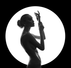 Art beauty Nude woman on black background in white circle ring. Perfect body, slim figure,...