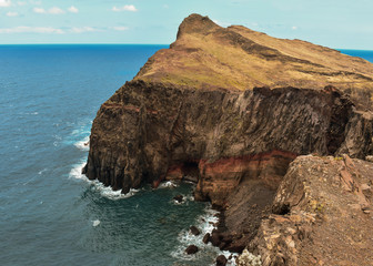 Naklejka premium Steep cliffs in Madeira and the Atlantic Ocean. Taken at St. Lawrence Peninsula