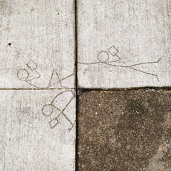 Stick figures etched in sidewalk reading books.