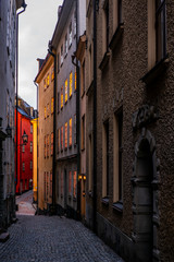 Obraz premium Old cobbled narrow street with coilorful houses in Stockholm in the morning - 8