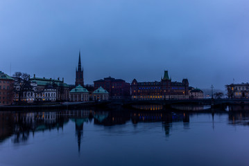 View of the building of the Norstedts Foerlag in Stockholm and the Vasabron bridge reflecting in the sea in the evening