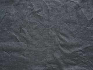 Fototapeta premium Gray linen texture as background. Gray linen crumpled tablecloth. Can use as mock up for design. Copy space for text