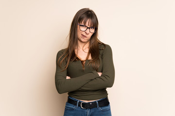 Young woman on ocher background feeling upset