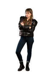 Full-length shot of Woman with glasses with confuse face expression while bites lip