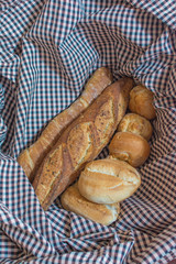 Different type of bread on a Kitchen tablecloth
