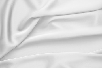 Obraz premium Rippled white silk fabric satin cloth waves background