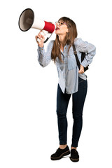 Full-length shot of Woman with glasses shouting through a megaphone