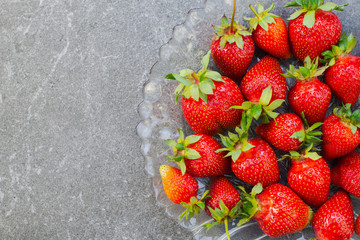 Organic ripened strawberries in a glass plate
