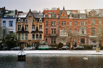 Fototapeta premium BRUSSELS, BELGIUM - JANUARY 30, 2019: Lake near residential areas, fallen snow, Flagey Avenue