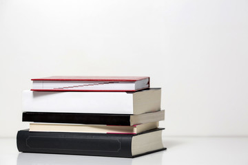 Reading books arranged on a white table. Background texture.