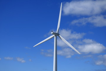 Wind turbine against blue sky
