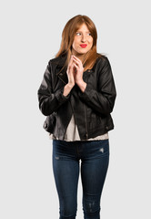 Young redhead woman scheming something over isolated grey background