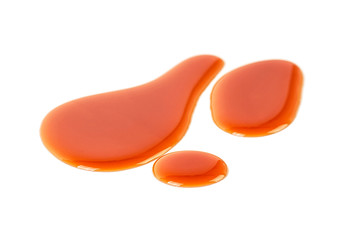 Caramel drops on a white background