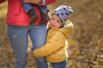 Mother and two sons,baby in arms of mom,son cries