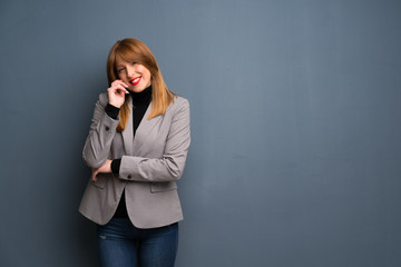 Redhead business woman smiling with a sweet expression