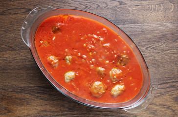 meat in glass transparent dishes on wooden table