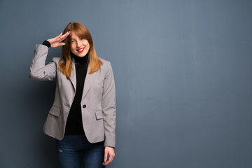 Redhead business woman saluting with hand