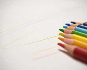 colored pencils on a white background with colored lines