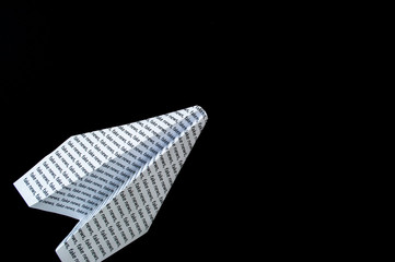 paper airplane on a black background
