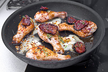 Roasted chicken legs with white cheese and tomatoes