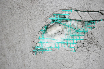 Texture of concrete. Layers of wall insulation, plaster, mesh, foam.