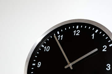 Five to two setting on the black wall clock