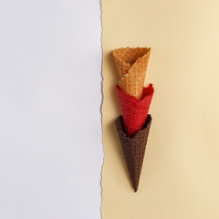 Waffle cone for ice cream on a paper background. Top view. Copy space. Minimalistic concept.