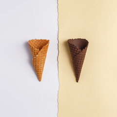 Waffle cone for ice cream on a paper background. Top view. Copy space. Minimalistic concept.