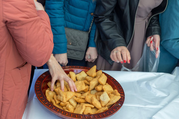 people celebrate the Kazakh holiday Nauryz. People distribute free national food, and many rush for food.