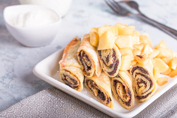 Delicious pancakes wrapped with poppy seeds