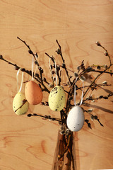A cup with eggs on a rustic window, willow branches, preparation for Easter, approaching spring