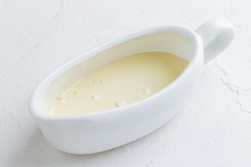 white gravy boat with condensed milk