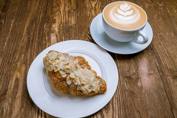 the almond croissant with a cappuccino