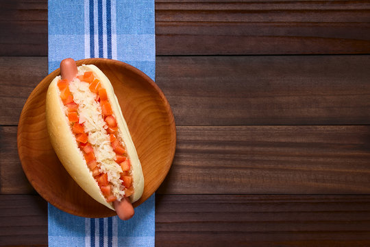 Chilean Completo Clasico (classical) Or Completo Aleman (German) Traditional Hot Dog Sandwich, Made Of Bread, Sausage, Tomato Cubes And Sauerkraut, Photographed Overhead 