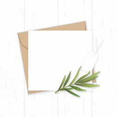 Flat lay top view elegant white composition letter kraft paper envelope nature tarragon leaf and tag on wooden background
