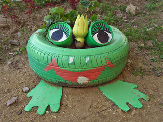 Flower bed in the shape of a frog, made from old tires