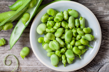 Fresh broad beans on the wooden board