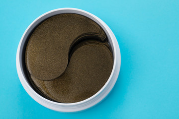 cosmetic eye patches in white box on blue background