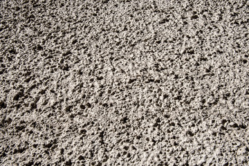Coarse concrete plaster on a house wall as a background