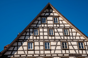 Fototapeta na wymiar Half-timbered house in Bad Urach on the market square in front of a blue sky