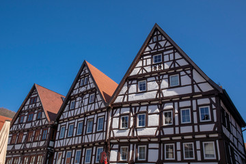 Fototapeta na wymiar Half-timbered house in Bad Urach on the market square in front of a blue sky
