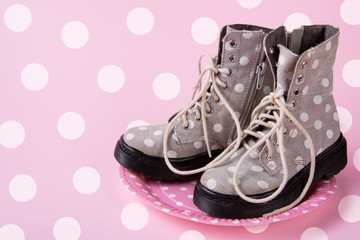 minimal concept of spring shopping, women's shoes with peas on a pink plate with peas, on a pink background with peas, original presentation