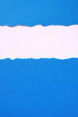 Torn blue paper strip untidy edge border frame vertical
