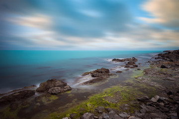 Fototapeta na wymiar Coastline with rock formations and blue sea.
