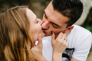 Fototapeta premium A woman kisses a man in a lips. Close up.