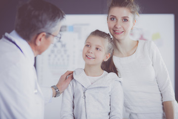 Fototapeta premium Little girl with her mother at a doctor on consultation