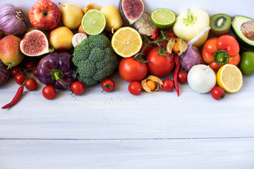Naklejka na ściany i meble Various fresh vegetables and fruits on a wooden background, top view, copy space.