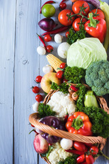 Heap of fresh fruits and vegetables on wooden background.