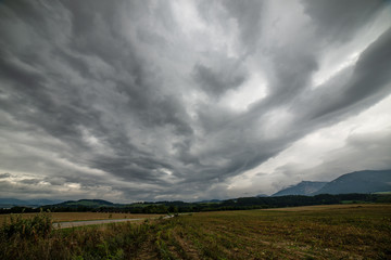 Naklejka na ściany i meble storm clouds over fields in slovakia