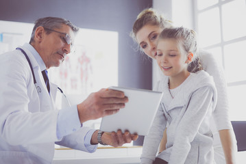 Little girl with her mother at a doctor on consultation